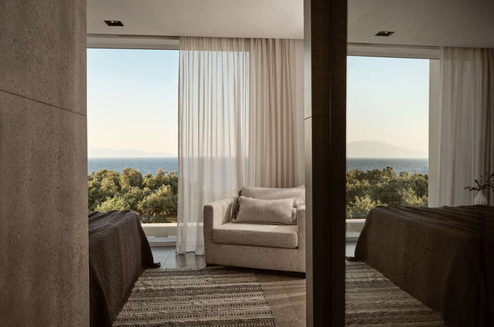 The bedroom also featuring an armchair & en-suite bathroom.